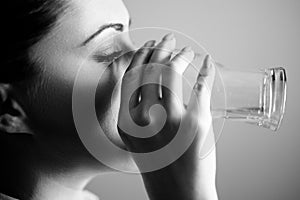 Girl drinking water from the glass