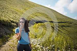 Girl drinking water from her hydration pack photo
