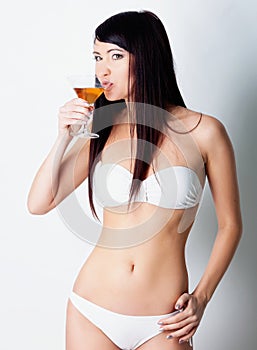 Girl drinking wine on white background