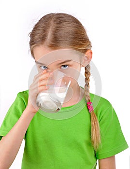 Girl drinks milk from a glass