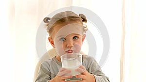 Girl drinks milk at home