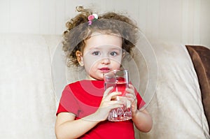 girl drinks pure fresh water from glass.