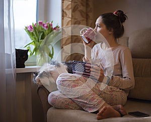 Girl drinks tea and dreams of spring