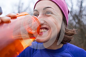 Girl drinks water after jogging