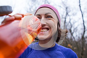 Girl drinks water after jogging