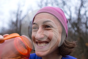 Girl drinks water after jogging