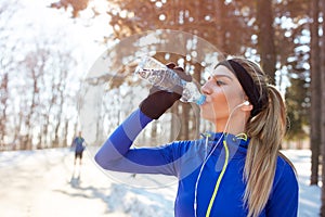 Girl drinks water on training outdoor