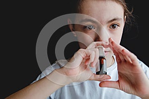 The girl drips into her nose with a spray of cold