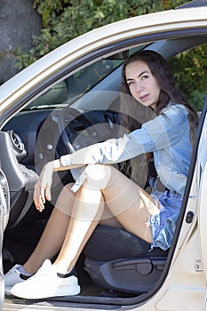 Girl driver take a selfie while driving his car. blur effect in the photo.