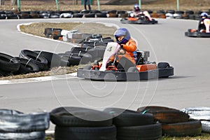 Girl is driving Go-kart car with speed in a playground racing track