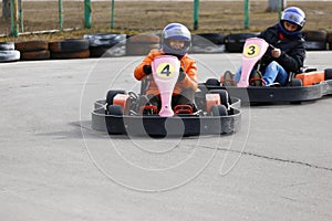 Girl is driving Go-kart car with speed in a playground racing track