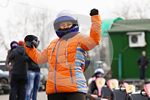 Girl is driving Go-kart car with speed in a playground racing track