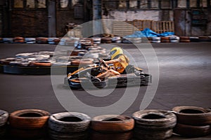 Girl driving a go kart at an indoor track