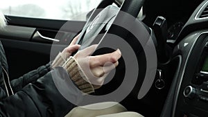 Girl driving her car in motion close up, hands on the steering wheel