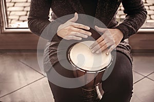 Girl drummers hands playing percussion bongo