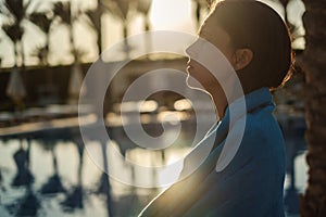 Girl drying with towel by the pool