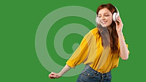 Girl In Earphones Listening To Music And Dancing, Green Background