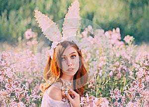 Girl easter bunny with creative ears on the hoop. Portrait of a young, red-haired woman with big beautiful eyes and lips