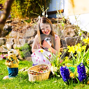 Girl on Easter egg hunt with living Easter Bunny