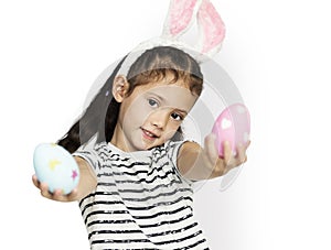 A girl with an easter eggs and bunny hairband