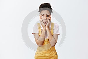 Girl easy to amaze with shocking rumors. Portrait of impressed amazed and surprised african-american female student in
