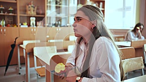 Girl eat apples in class during recess.