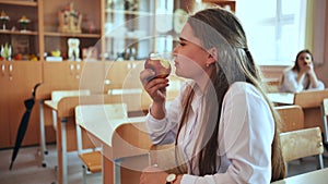 Girl eat apples in class during recess.