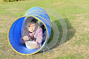 Girl eating in blue kids tunnel