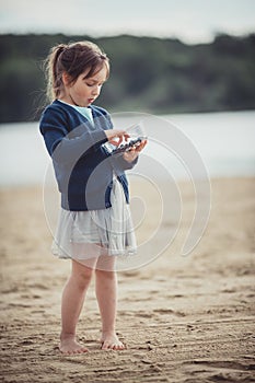 The girl eating blueberries from a glass bowl