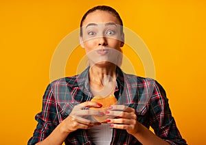 Girl Eating Burger Having Cheat Meal Standing On Yellow Background