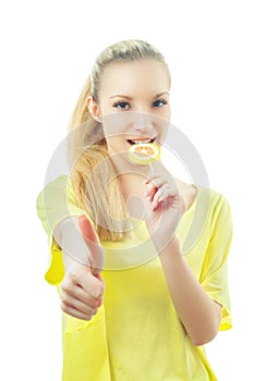 Girl eating candy showing OK