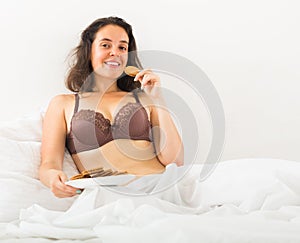 Girl eating cookies in bed