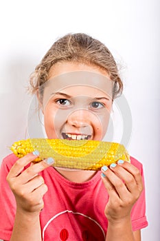 Girl eating corn. Healthy food for children