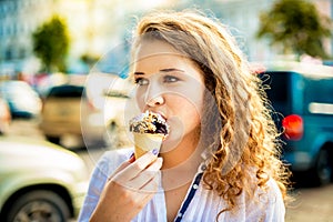 Girl eating a delicious chocolate ice cream