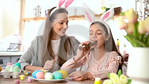 Girl eating delicious chocolate rabbit