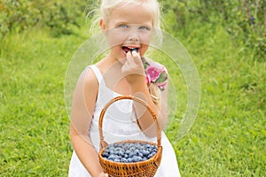 Girl eating delicious and healthy blueberries