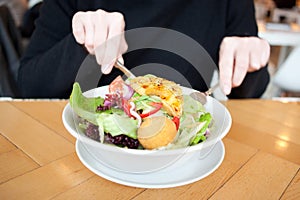 Girl eating a fresh garden salad