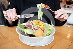 Girl eating a fresh garden salad