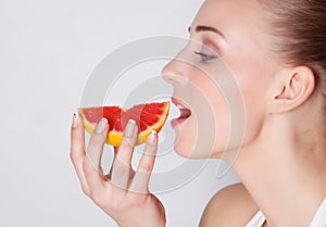 Girl eating grapefruit