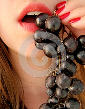 Girl eating grapes