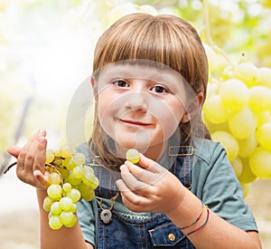 Girl eating grapes in the vineyards