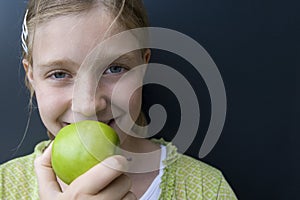 Girl eating a green apple