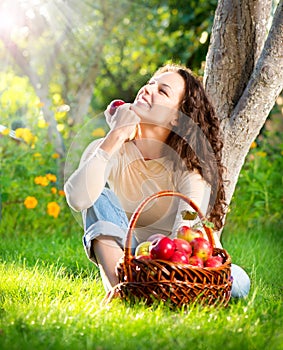 Girl Eating Organic Apple in the Orchard