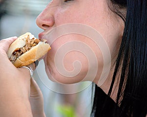 Girl Eating a Sandwich - Close up photo