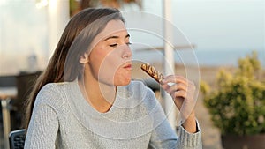 Girl eating a snack in a coffee shop in slow motion