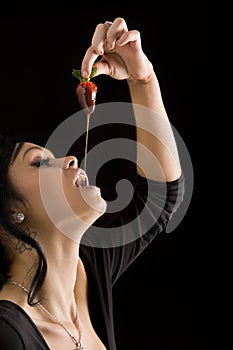 Girl eating a strawberry