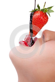 Girl eating strawberry with chocolate sauc