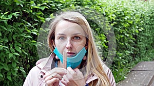 Girl Is Eating A Sweet Stick In A Medical Mask