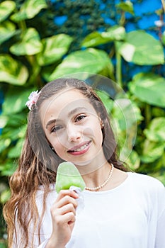 Girl eating a traditional water ice cream typical of the Valle del Cauca region in Colombia