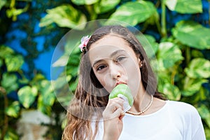 Girl eating a traditional water ice cream typical of the Valle del Cauca region in Colombia